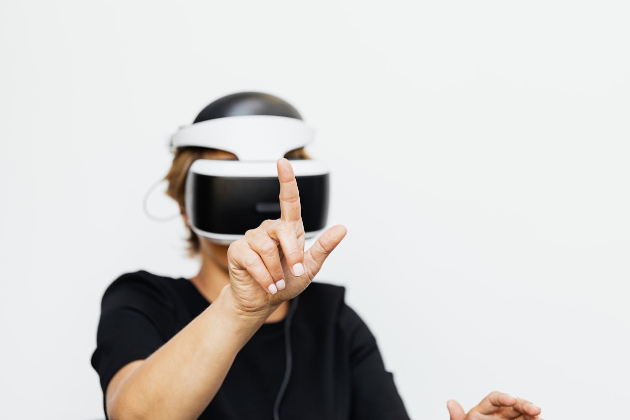 Woman interacting with virtual reality technology in a modern setting, wearing a VR headset on a white background.